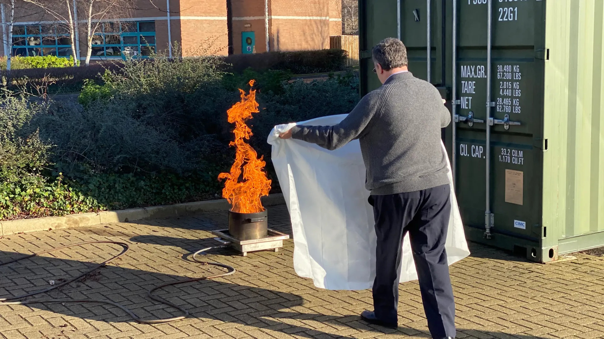 Fire Blanket Training on a live fire during Kings Fire Training Day at a clients premises
