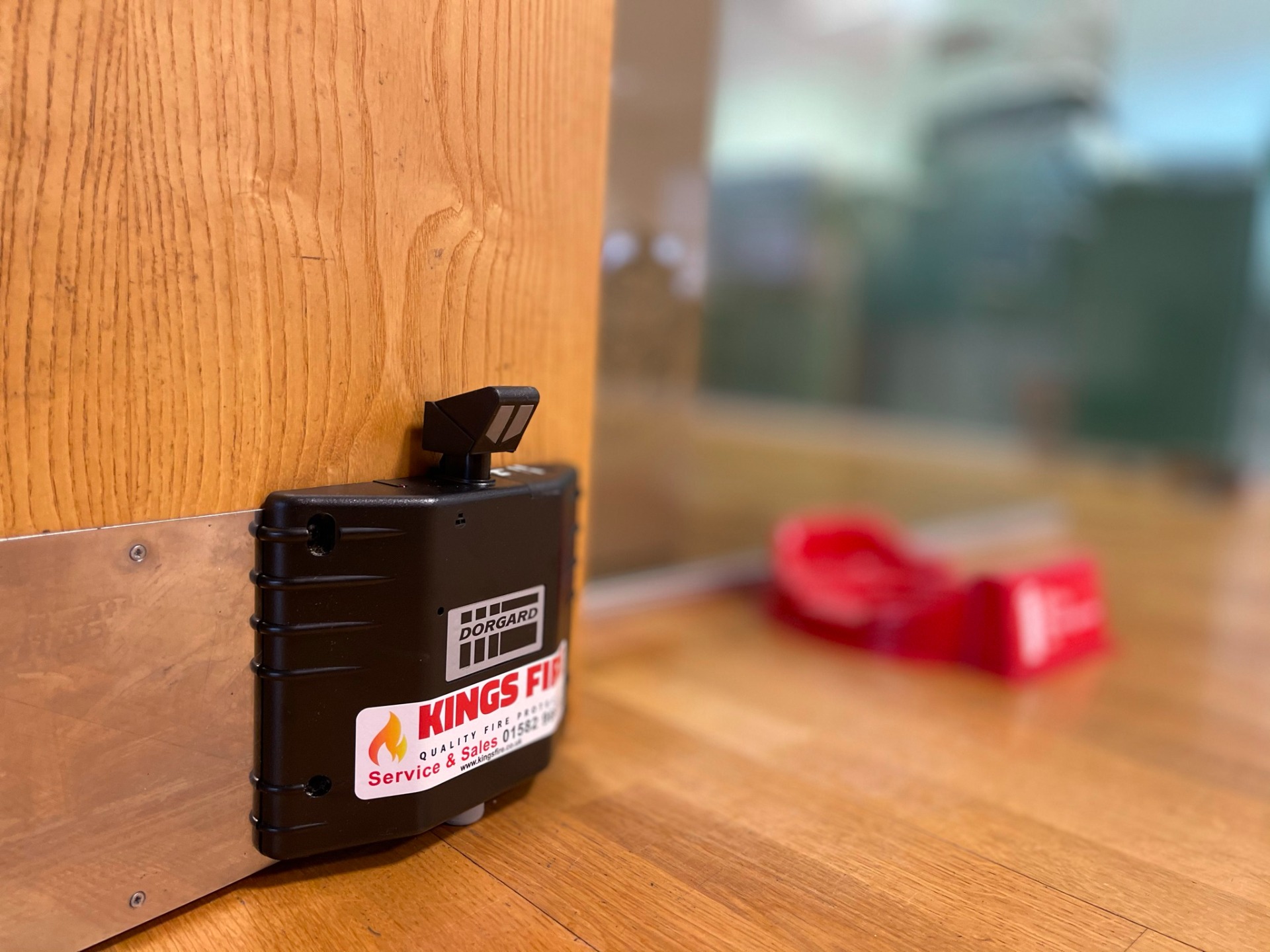 Professionally installed Dorgard wireless fire door retainer at floor level