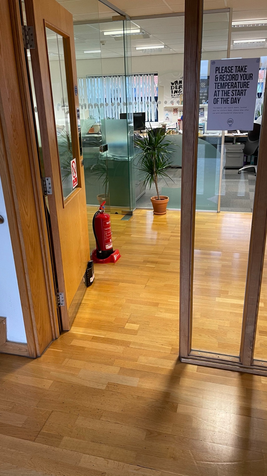 Office fire door held open safely using a Dorgard fire door retainer